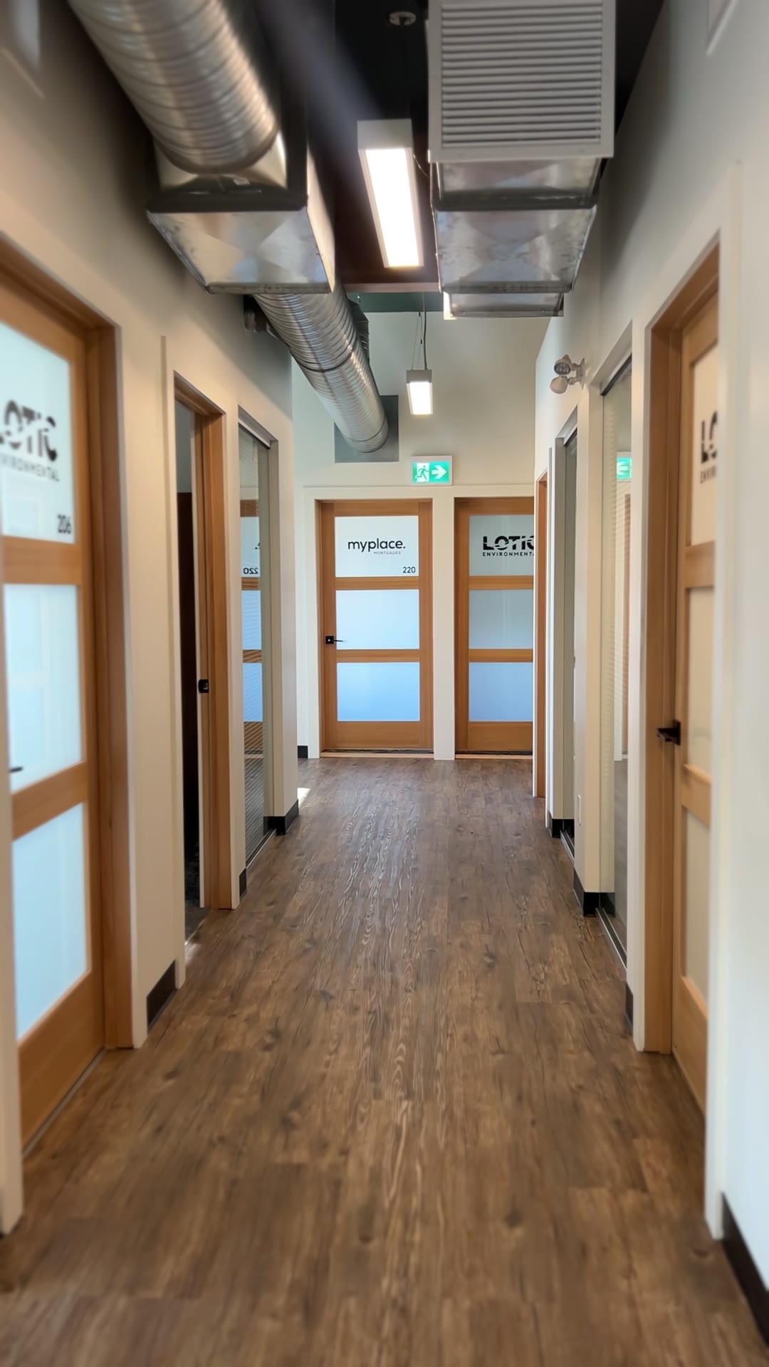Hallway of private offices with oak doors